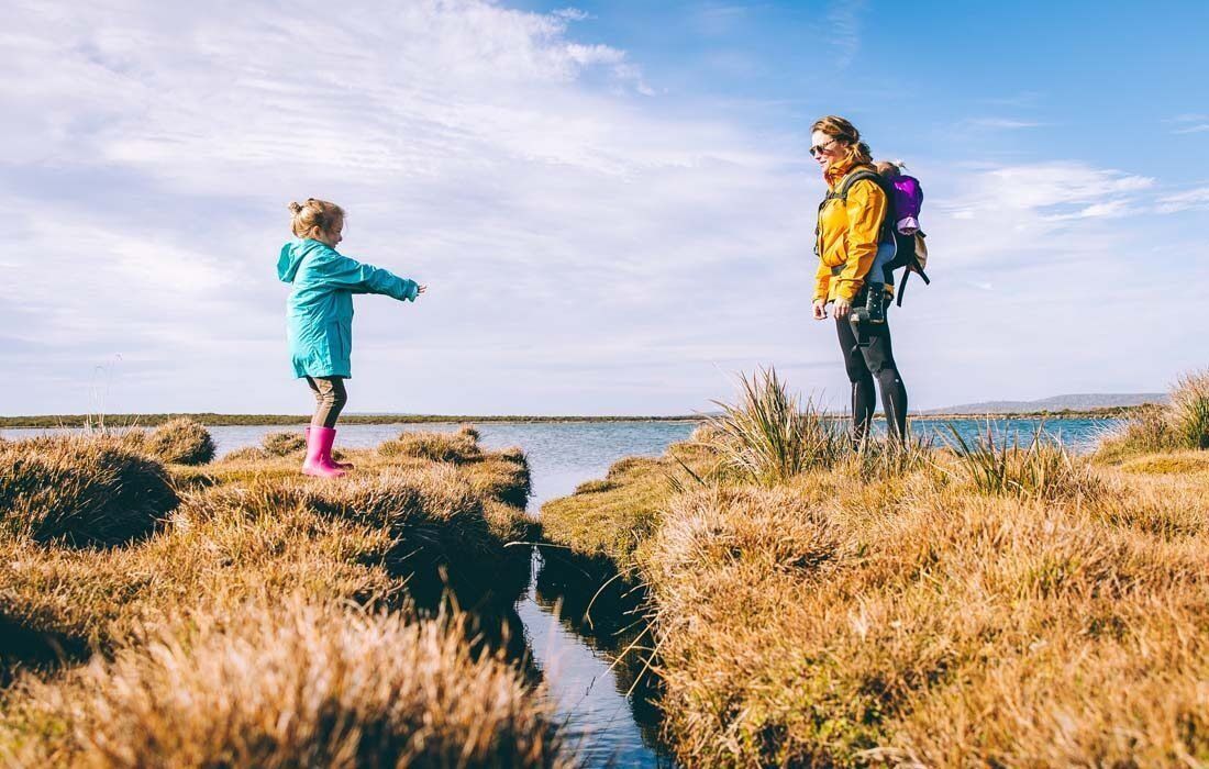 A Woman and a Child Are Standing in a Field — MoneySmith Group In Kingscliff, NSW