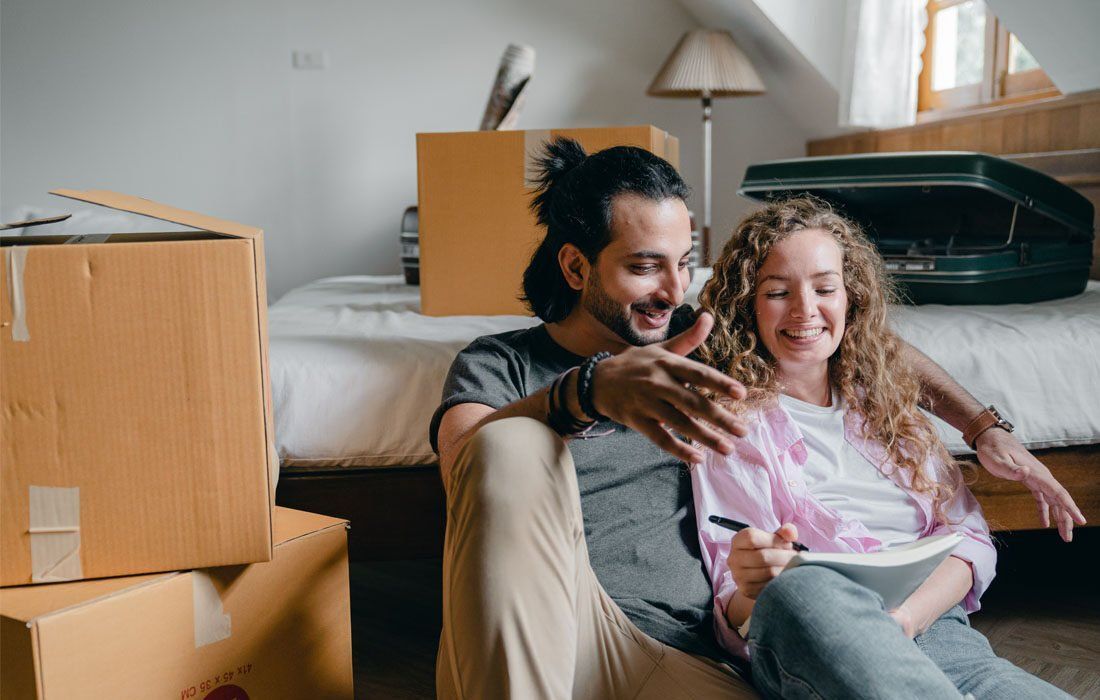 A Couple Sitting on the Floor in a Room — MoneySmith Group In Kingscliff, NSW