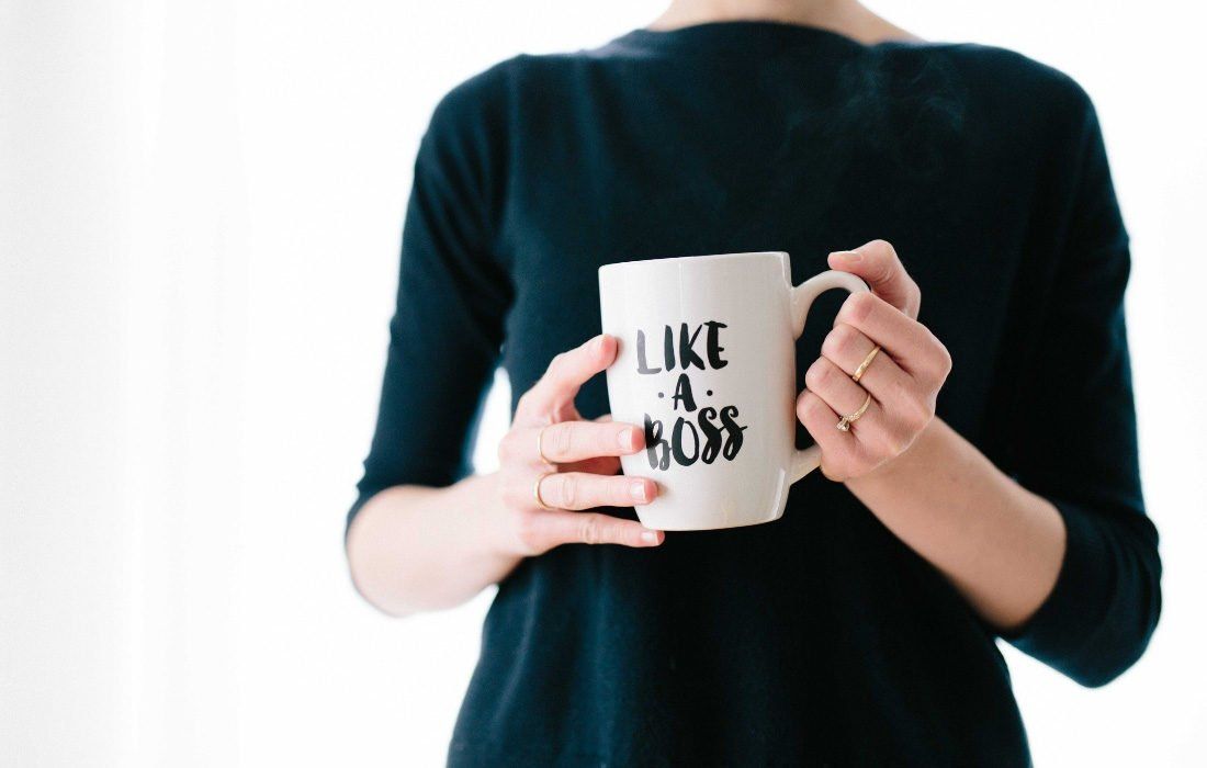 A Woman is Holding a Coffee Mug — MoneySmith Group In Kingscliff, NSW