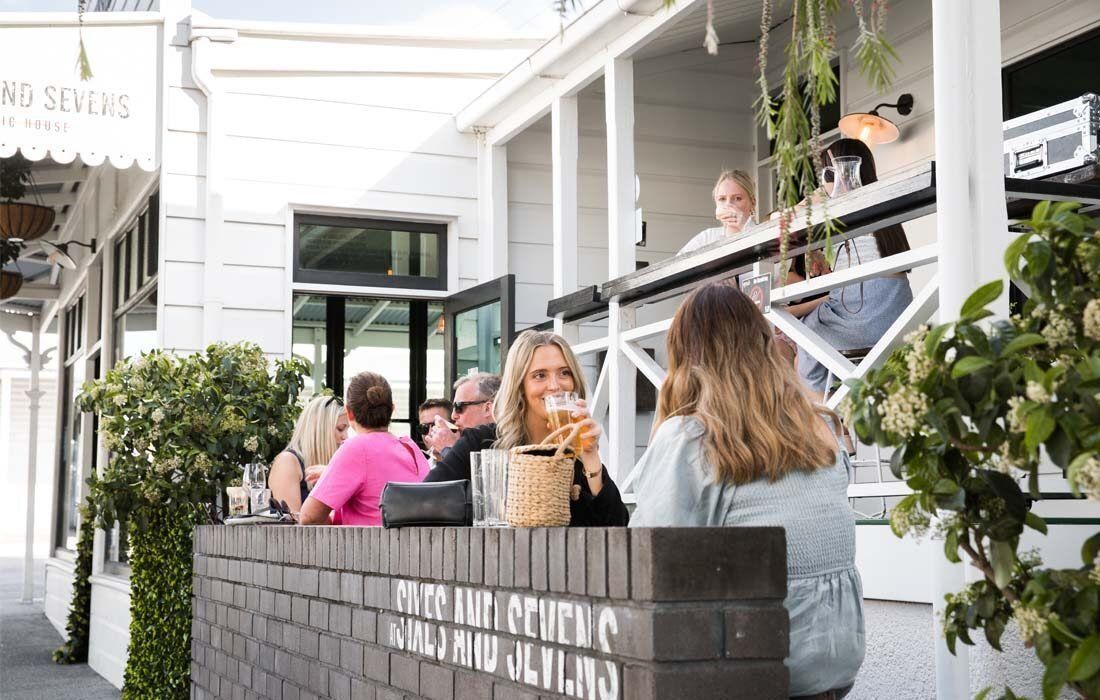 Group of People Are Sitting on a Porch — MoneySmith Group In Kingscliff, NSW