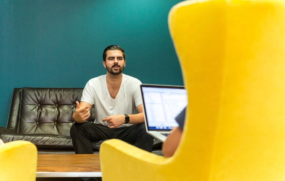 A Man is Sitting in a Yellow Chair — MoneySmith Group In Kingscliff, NSW