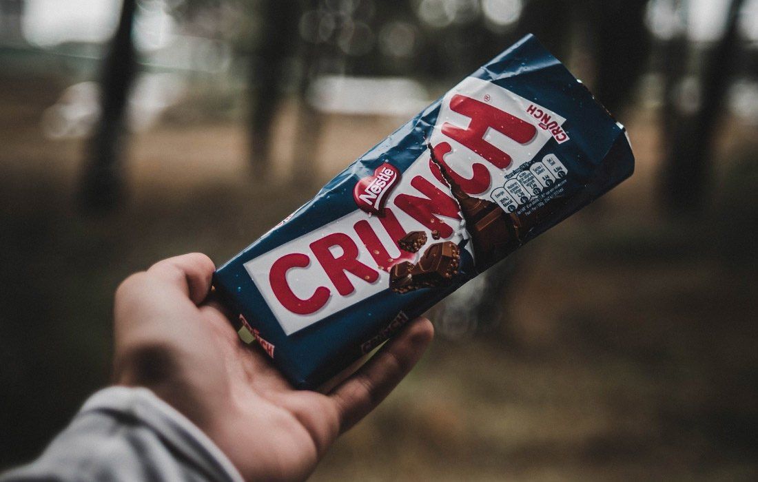 A Person is Holding a Crunch Bar — MoneySmith Group In Kingscliff, NSW