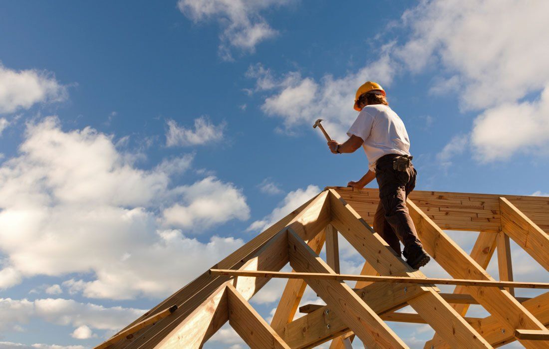 Man is Standing on Top of a Wooden Structure — MoneySmith Group In Kingscliff, NSW