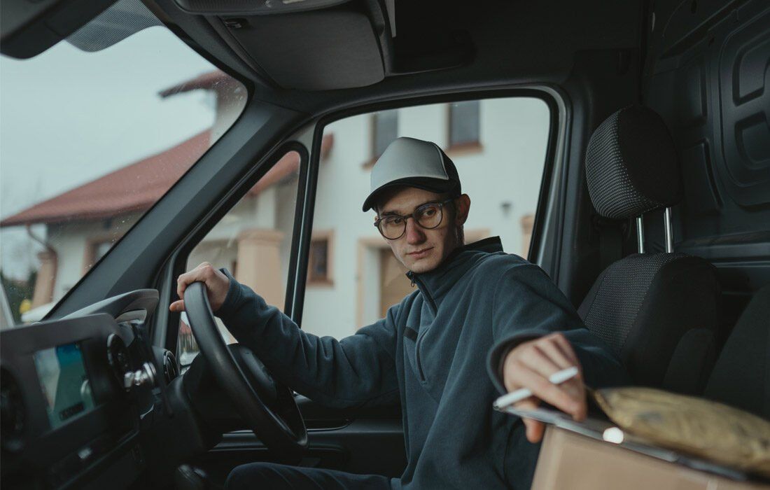 A Delivery Man is Sitting in the Driver 's Seat — MoneySmith Group In Kingscliff, NSW