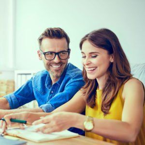 A Man and a Woman Are Sitting at a Table — MoneySmith Group In Kingscliff, NSW