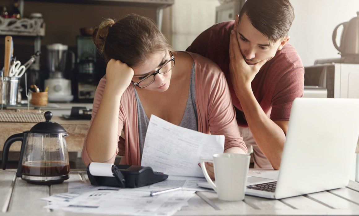 A Man and a Woman Are Sitting at a Table — MoneySmith Group In Kingscliff, NSW