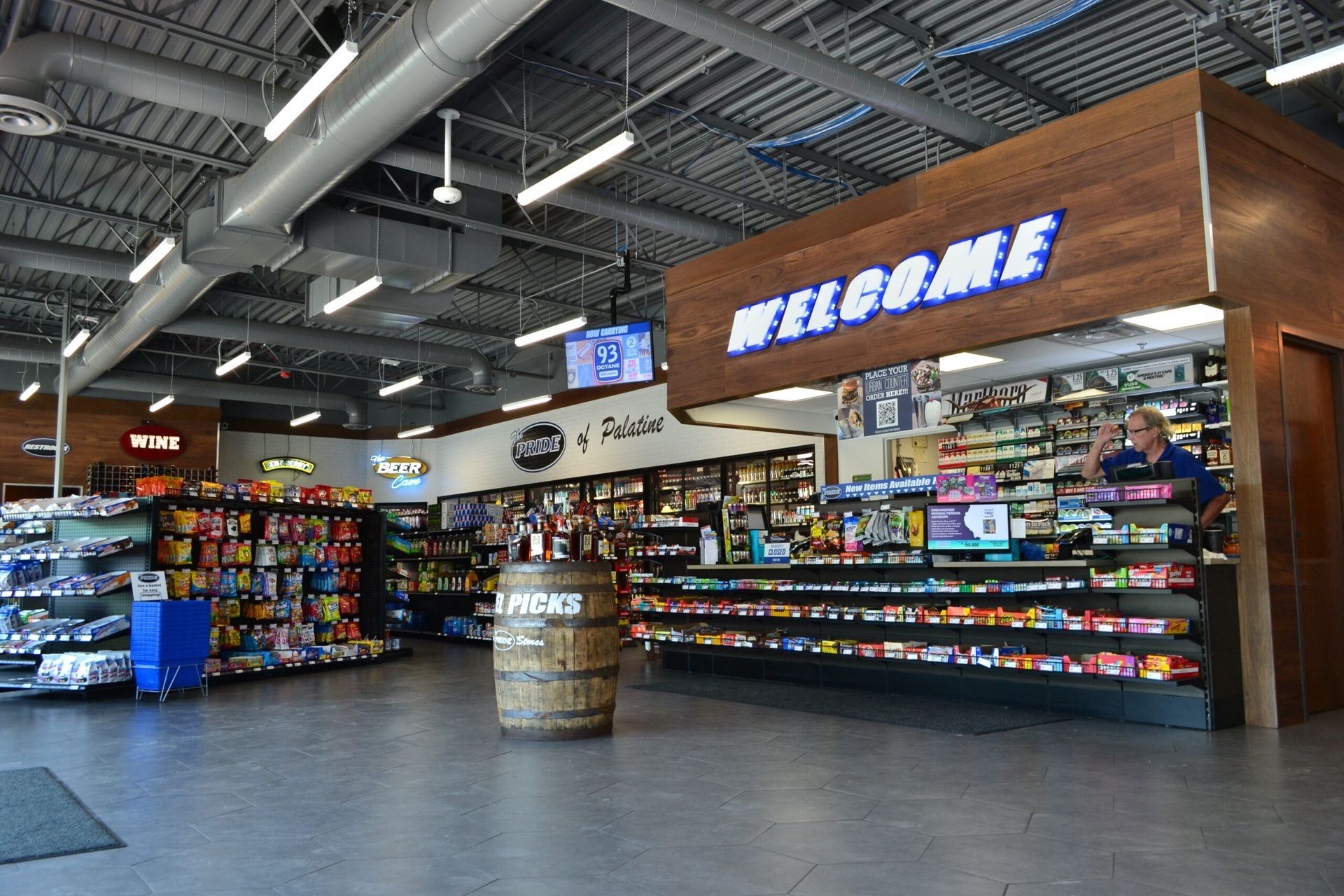 A grocery store with a welcome sign above the counter.