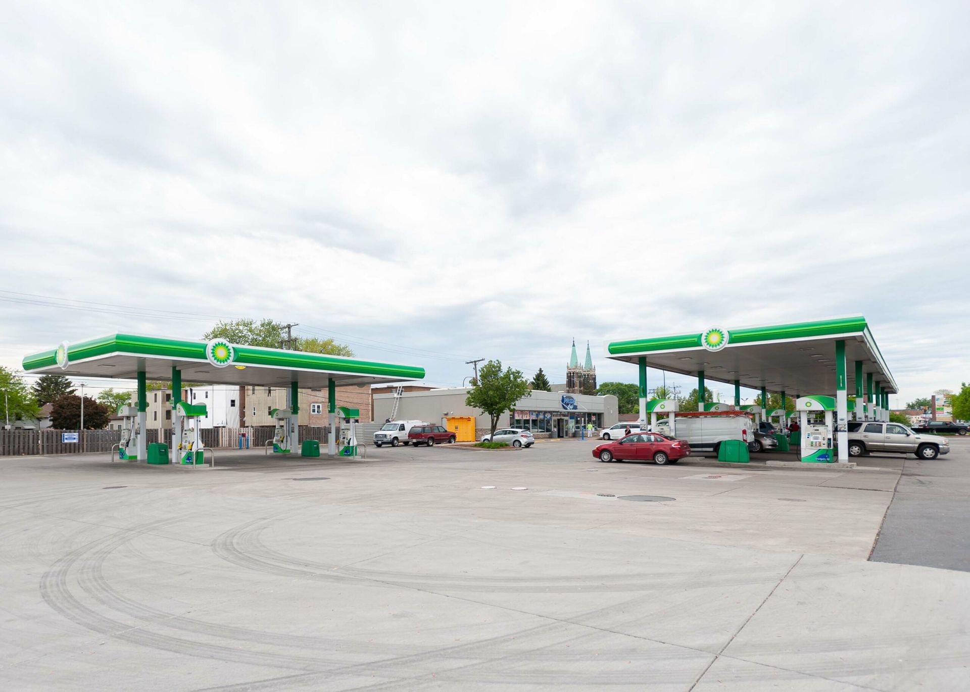 A bp gas station with cars parked in front of it.