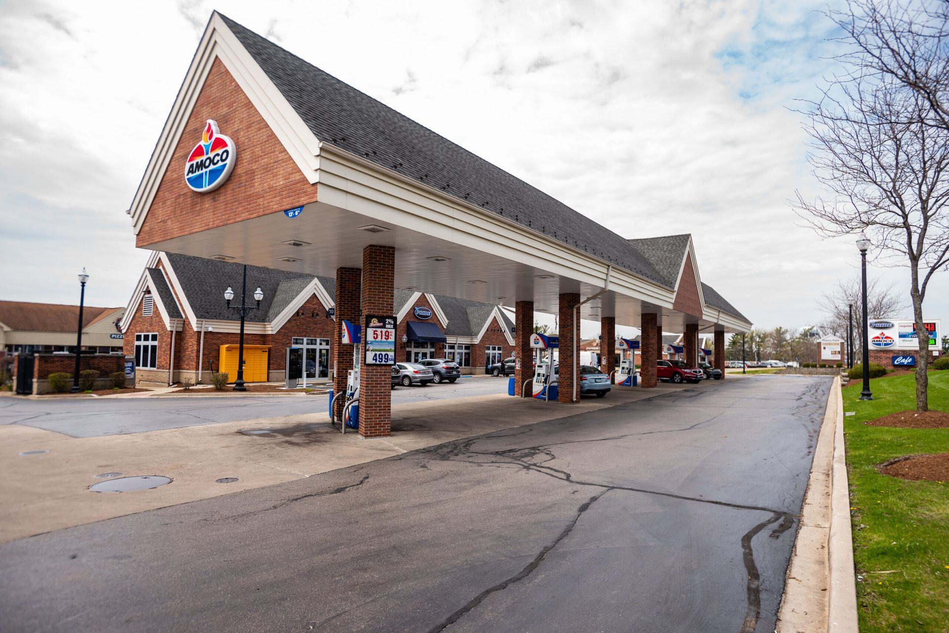 A gas station with a lot of cars parked in front of it.