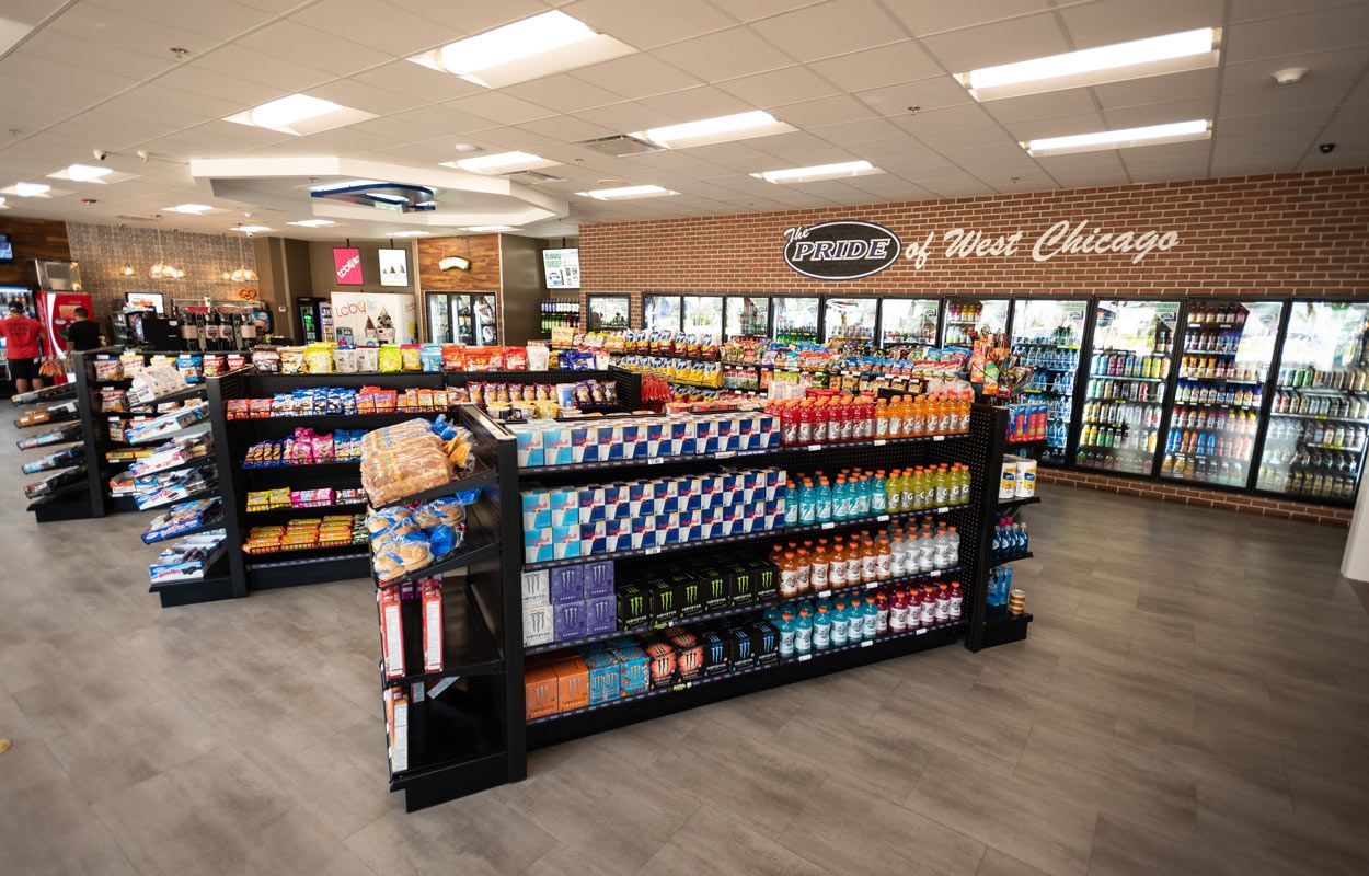 A grocery store filled with lots of shelves and coolers.