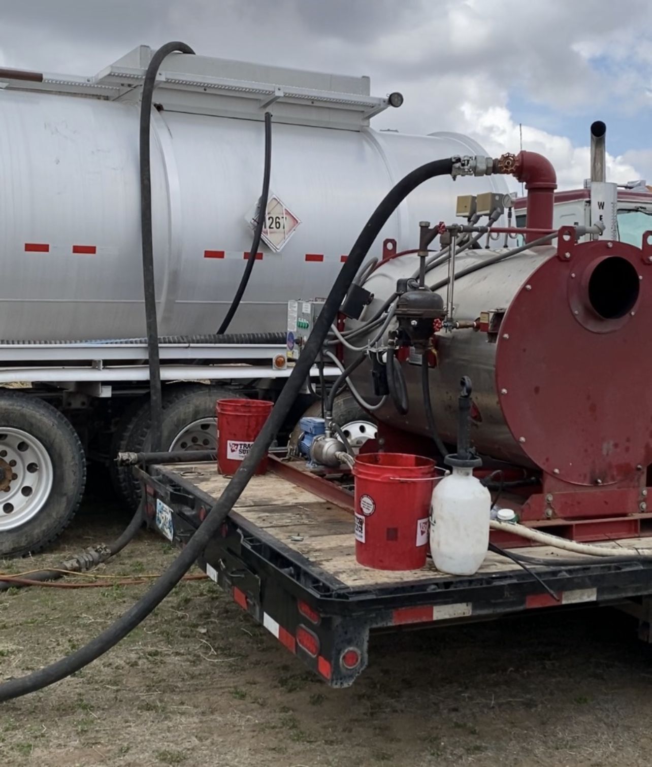 A tanker truck with a hose attached to it