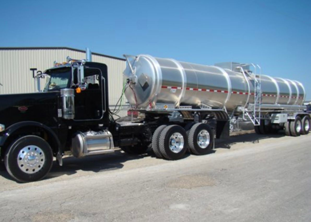 A large tanker truck is parked on the side of the road