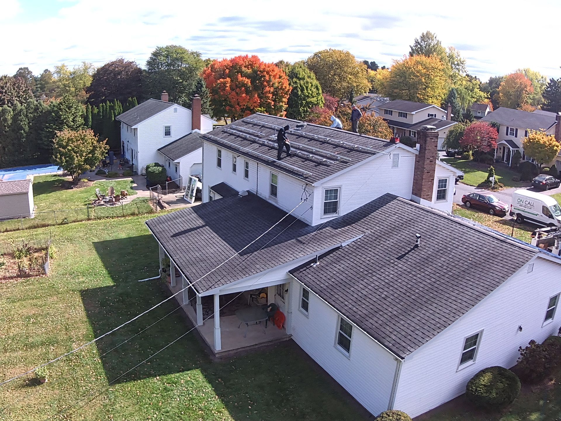 An aerial view of a house with solar panels on the roof.