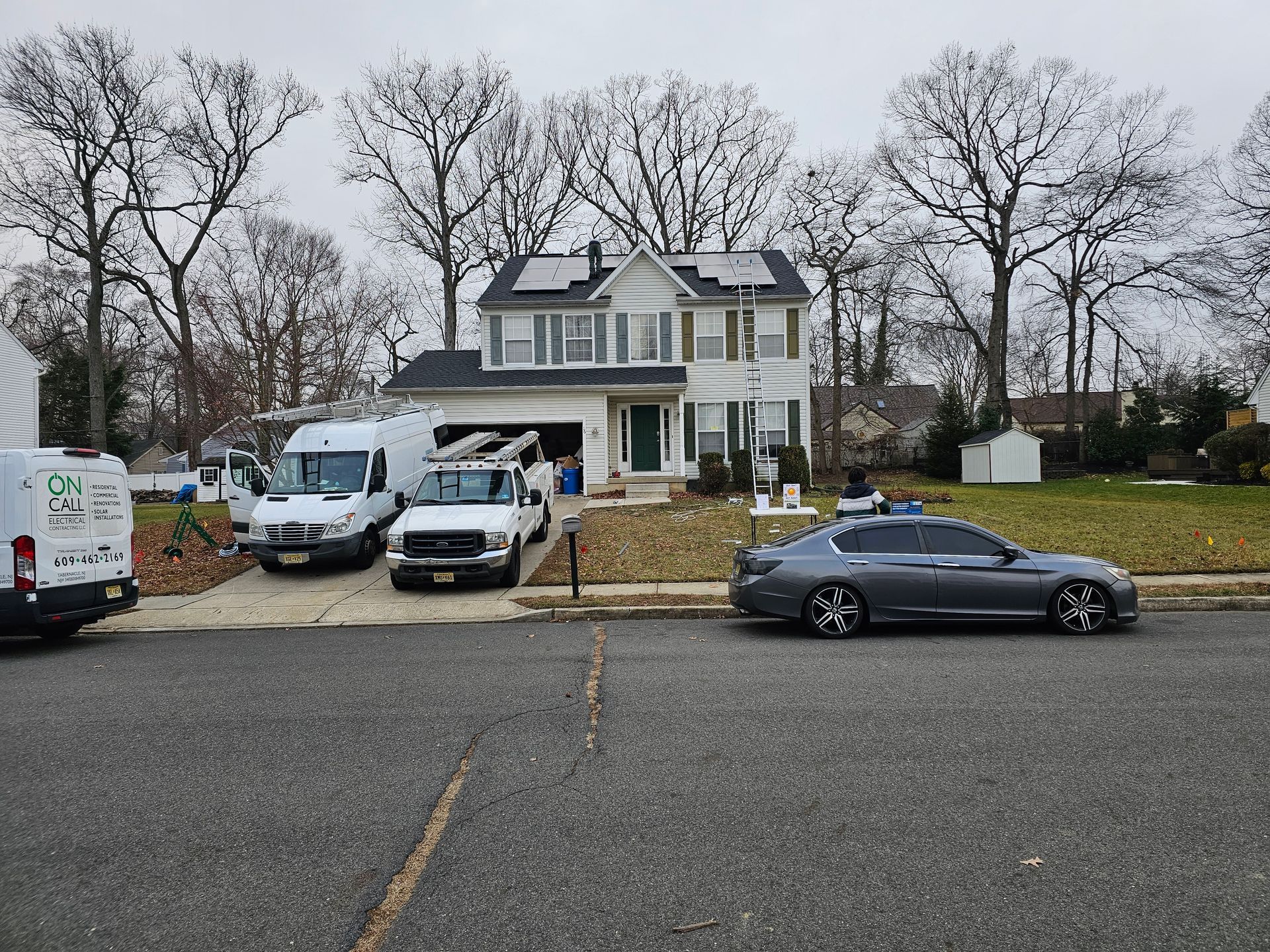 A house with a lot of cars parked in front of it.