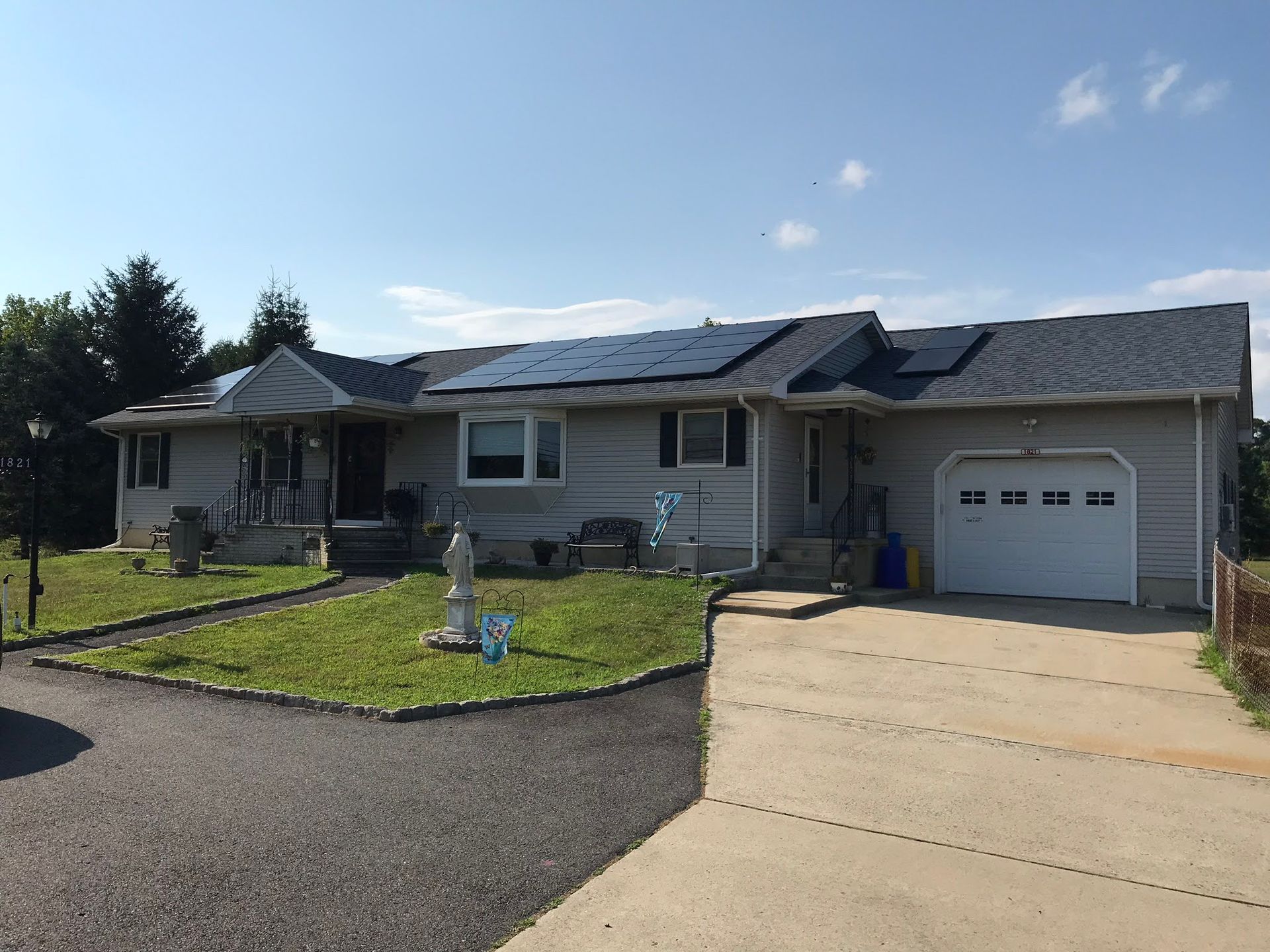A house with a garage and solar panels on the roof.
