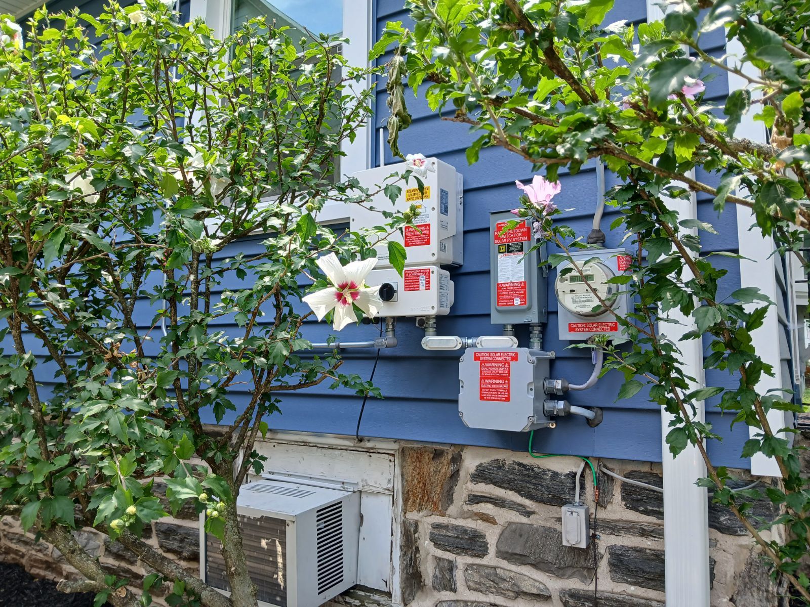 A blue house with a meter on the side of it