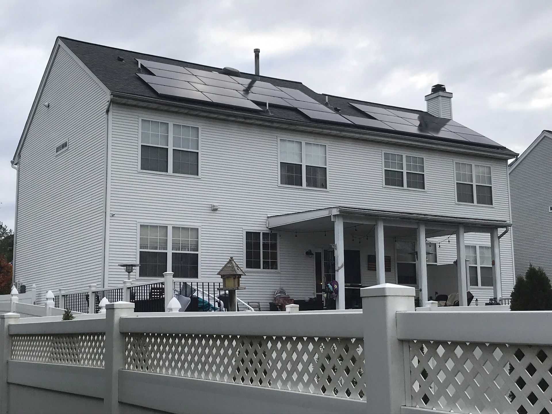 A white house with solar panels on the roof