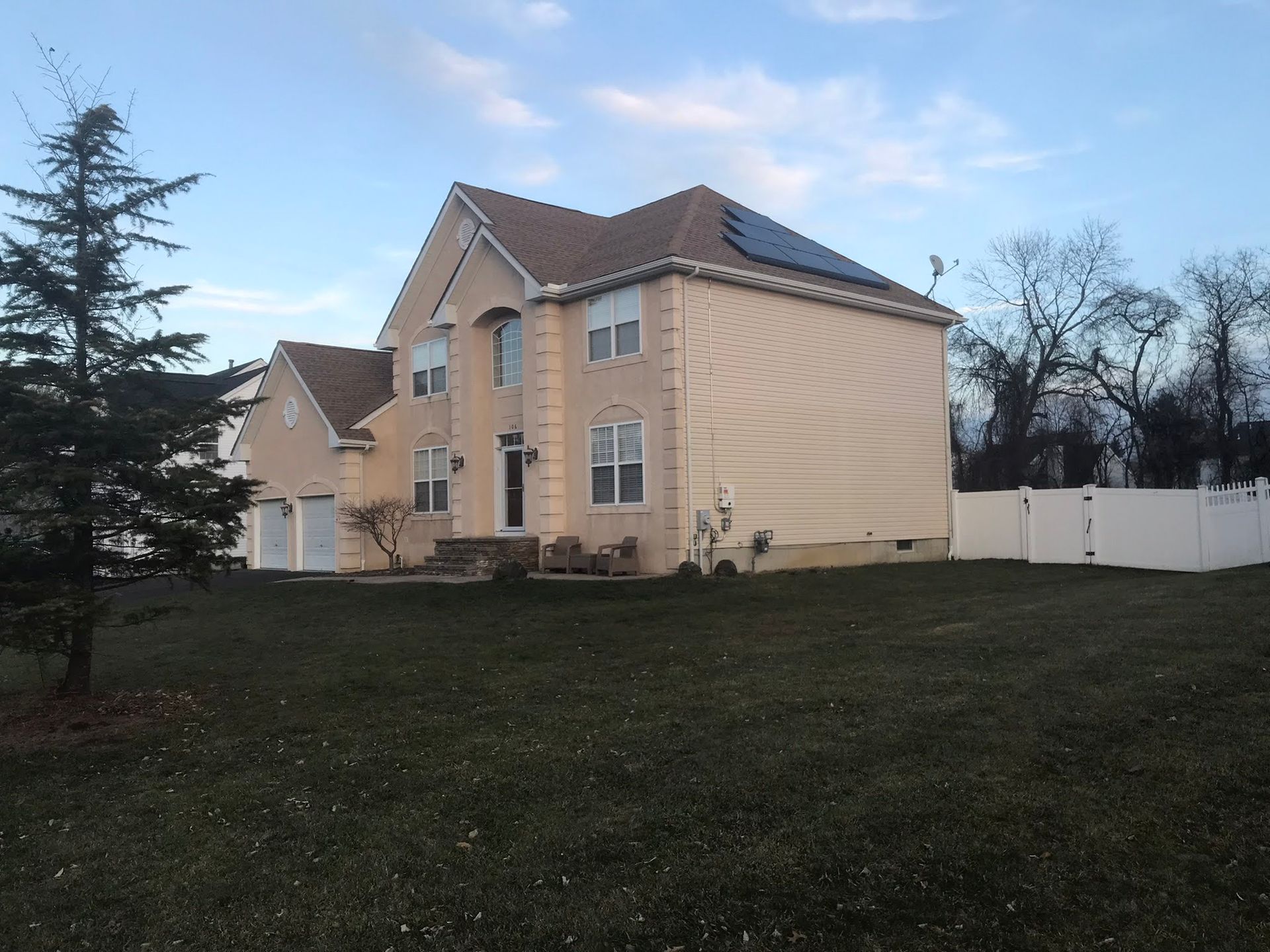 A large house with solar panels on the roof