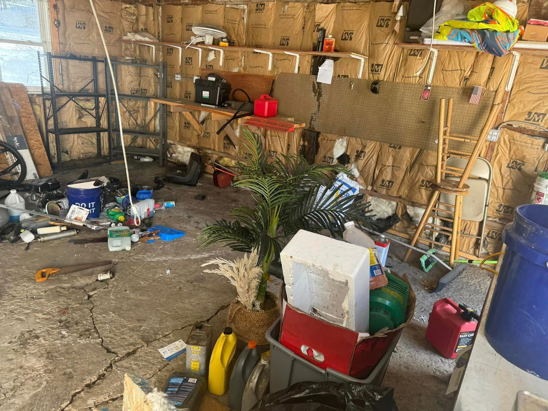 A messy garage filled with lots of junk and boxes.