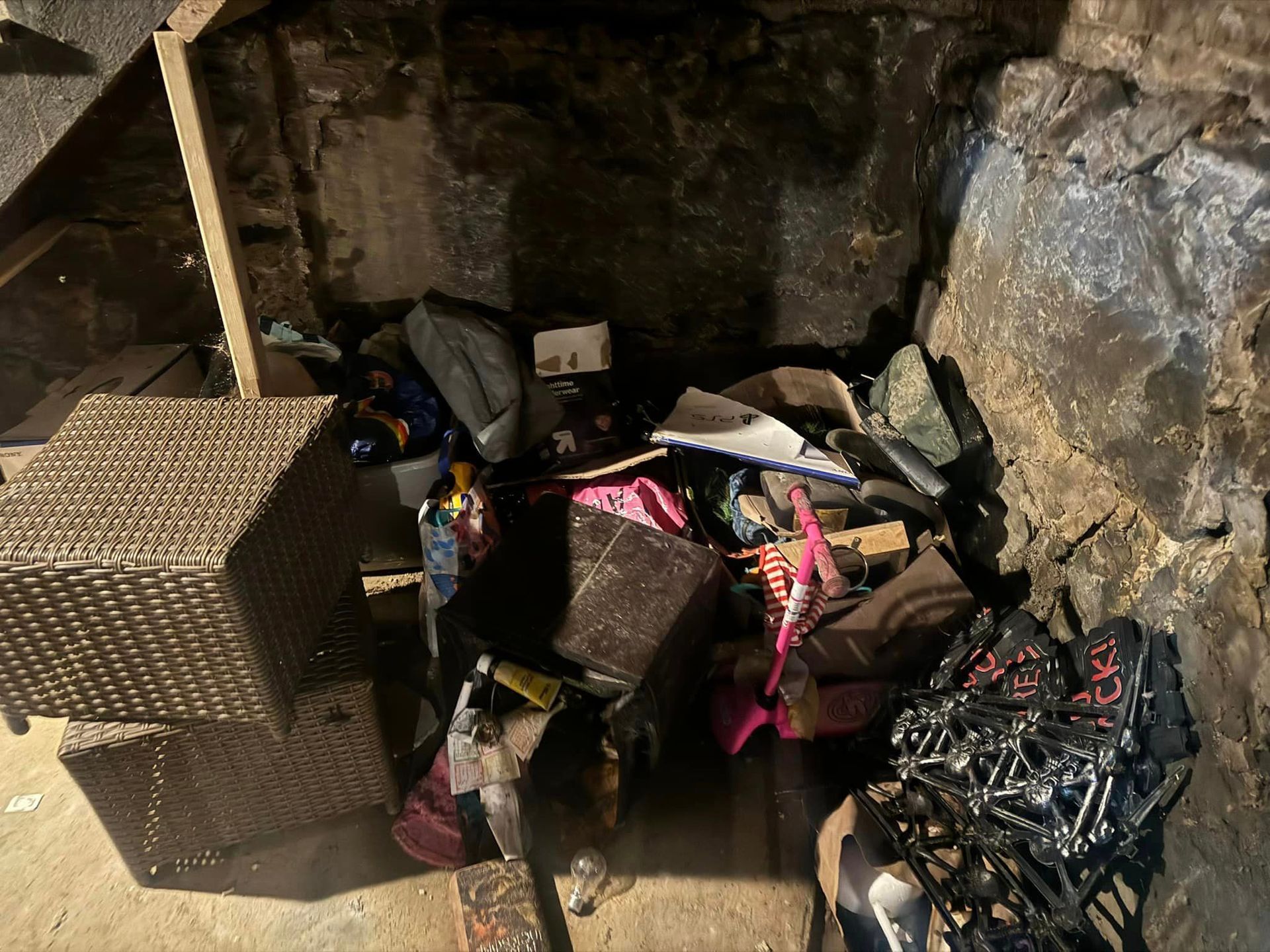 A pile of trash is sitting in a corner of a room