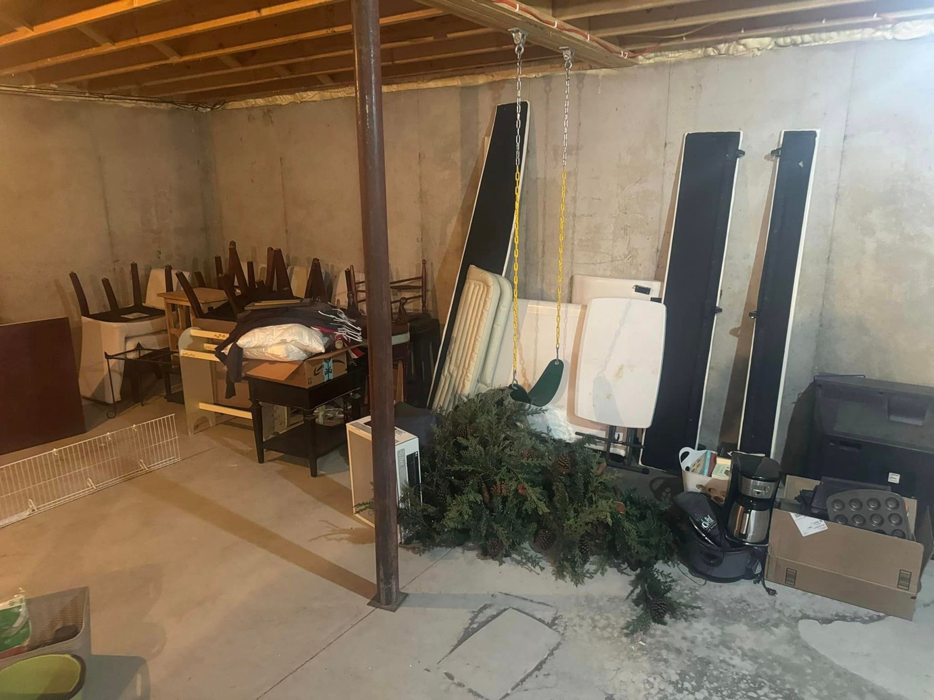 A basement filled with lots of furniture and junk.