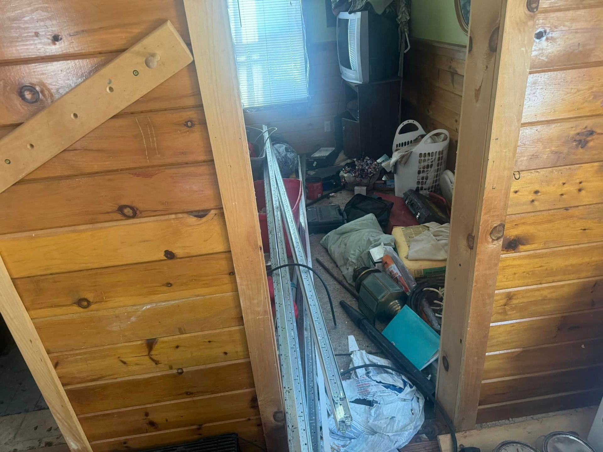 A room with a lot of stuff in it and a wooden wall.