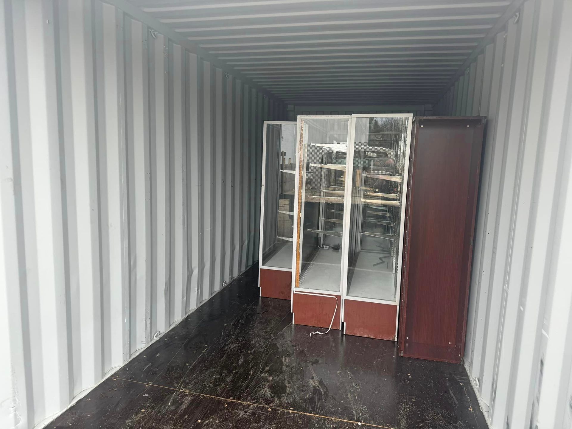 A shipping container filled with shelves and cabinets.