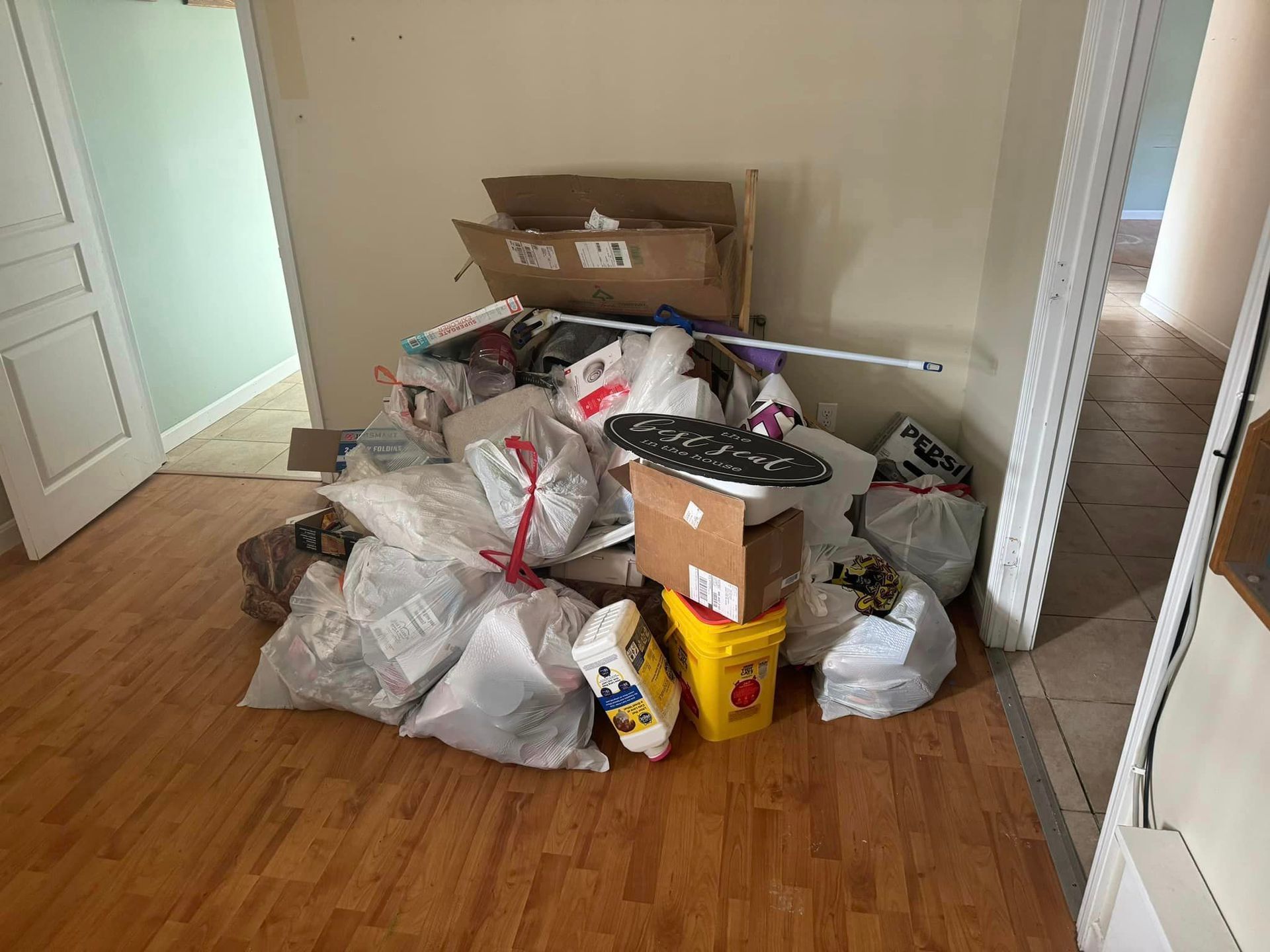 A room filled with bags , boxes , and other items.