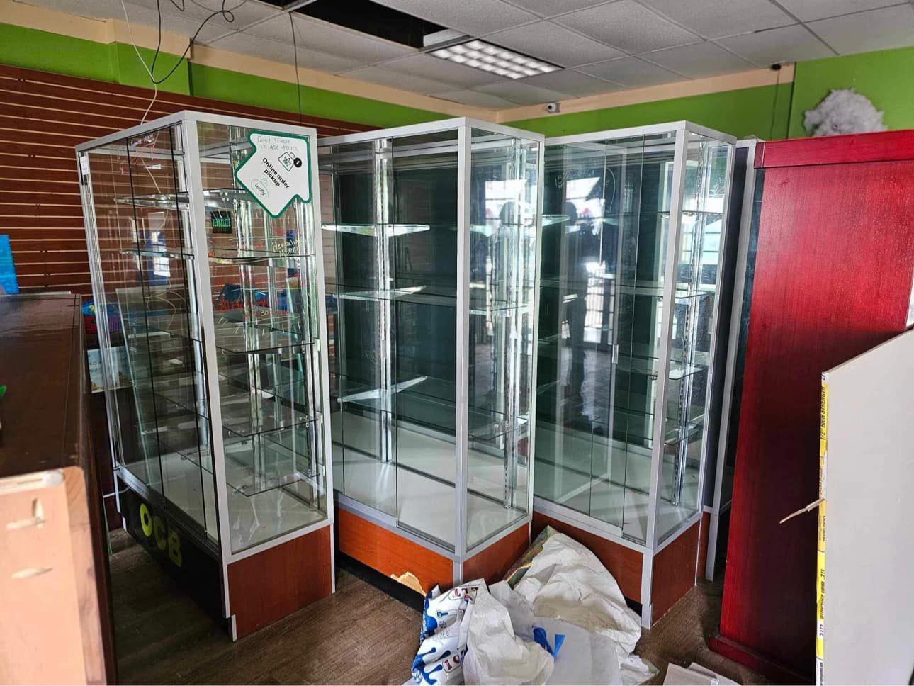 A row of glass display cases are lined up in a room.