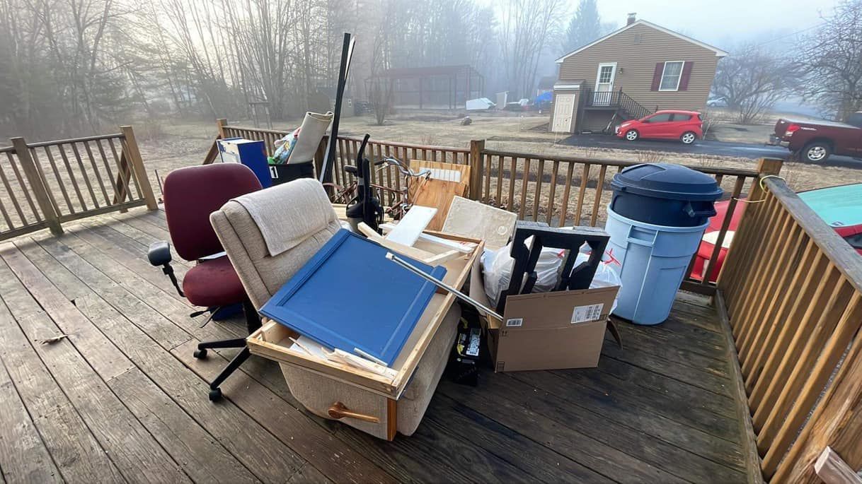 A deck filled with furniture and boxes on a foggy day.