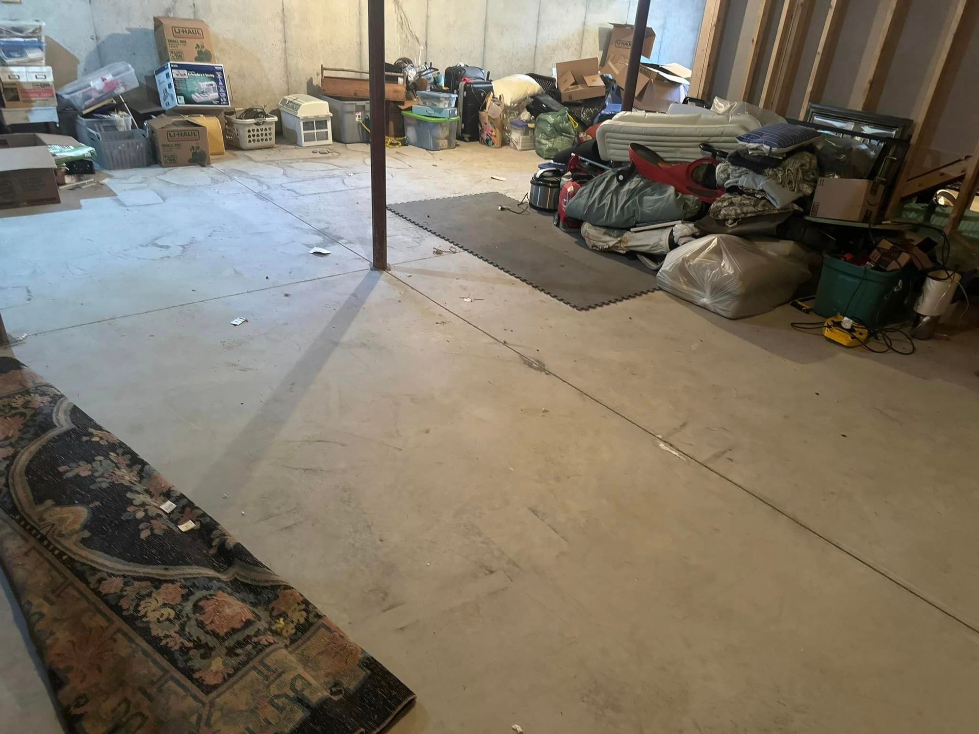 A basement filled with lots of boxes and bags.