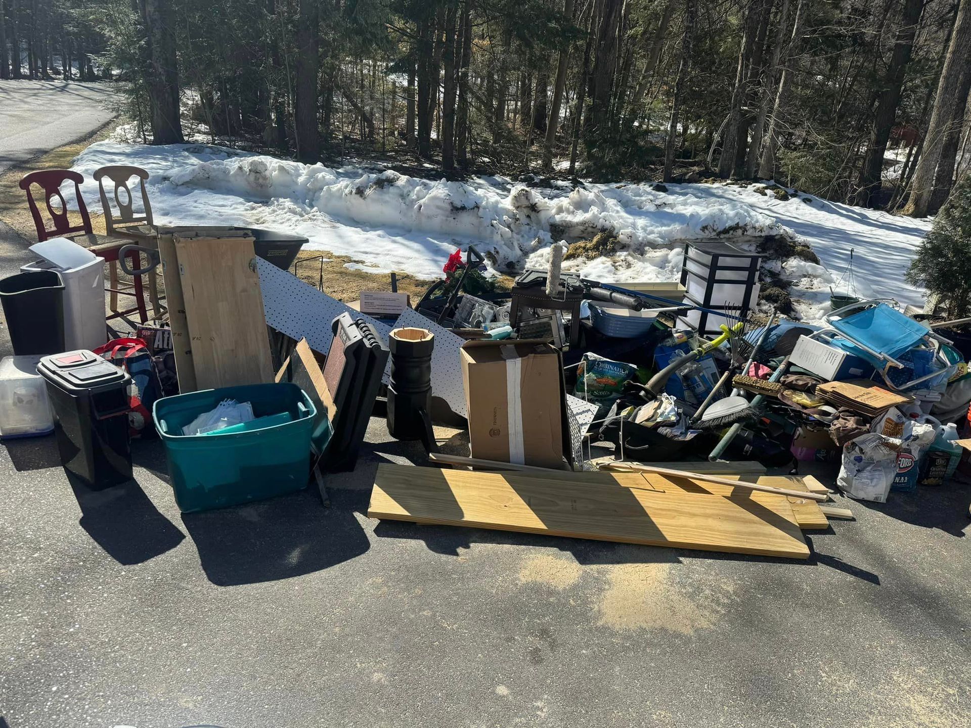 A pile of trash is sitting on the side of a road.