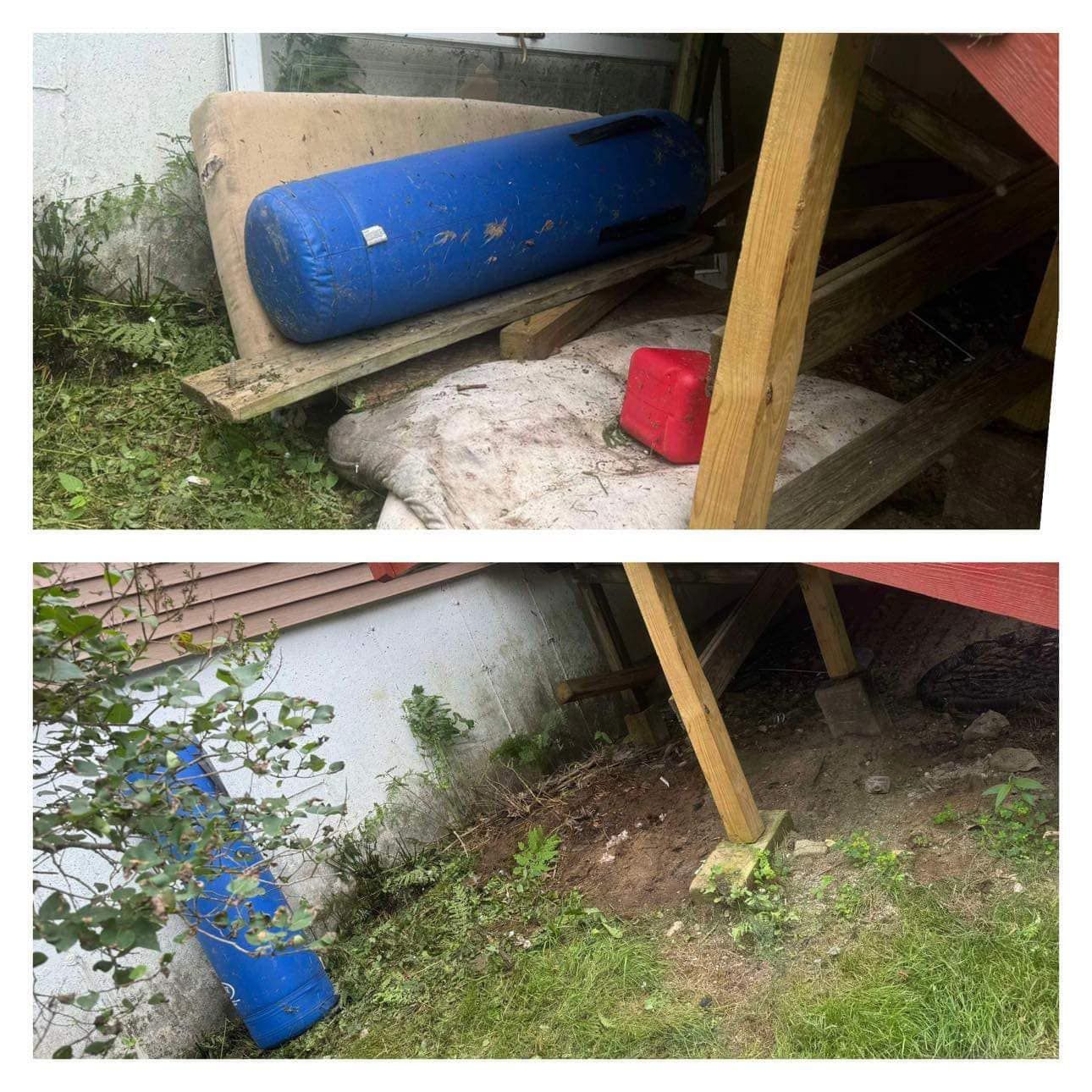 A blue barrel sits in the grass next to a red container