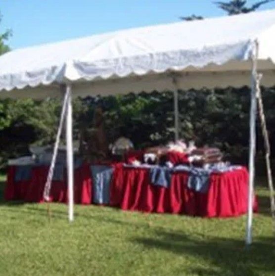 A white tent with red and blue tables underneath it