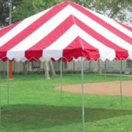 A white tent with red and blue tables underneath it