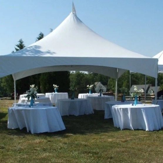 A white tent with tables underneath it