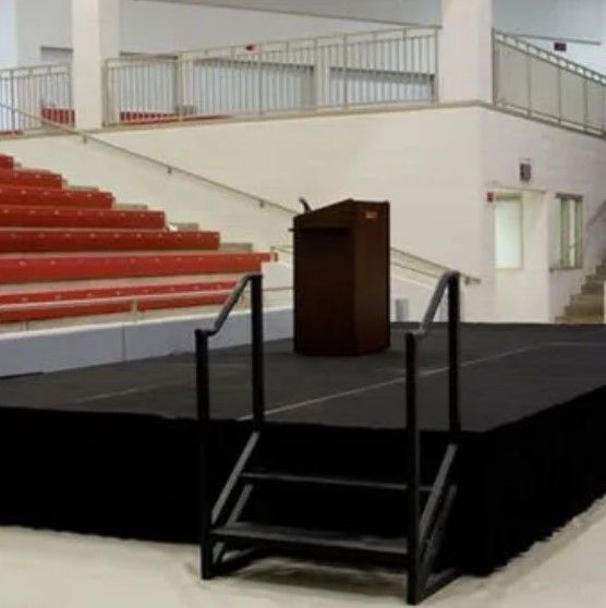 A stage with stairs and a podium in a stadium