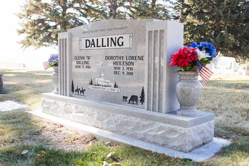 Side view of Dalling headstone showing engraved farm scene and family name across top