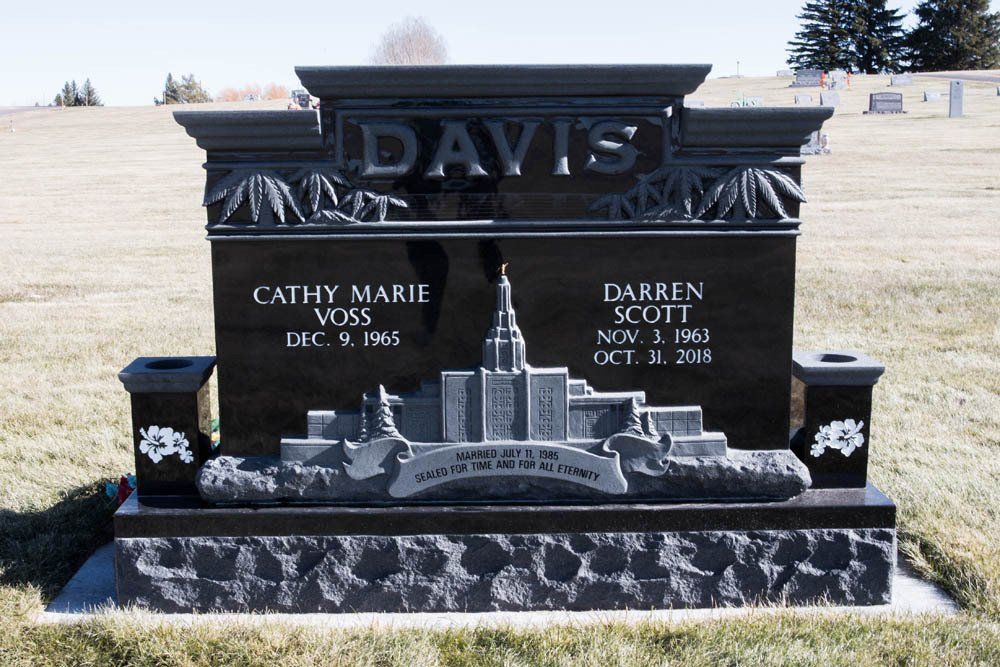 Front-facing granite headstone for the Davis family with Salt Lake Temple and decorative top engraving