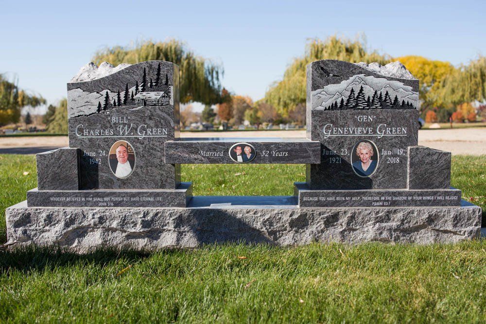 Granite companion headstone for the Green family with nature-themed etching and dual photo medallions
