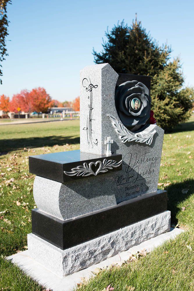 Side view of Jacobs angel-themed memorial with floral carvings and heart-shaped medallion in center