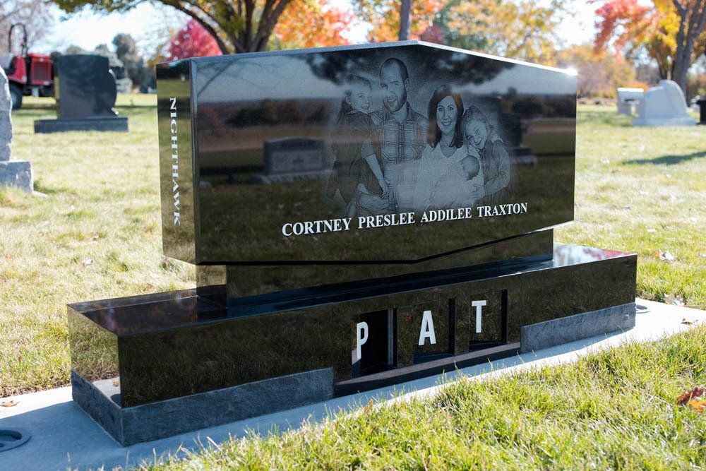 Side view of Cortney Presley Addilee Traxton headstone showing engraved family image and base lettering