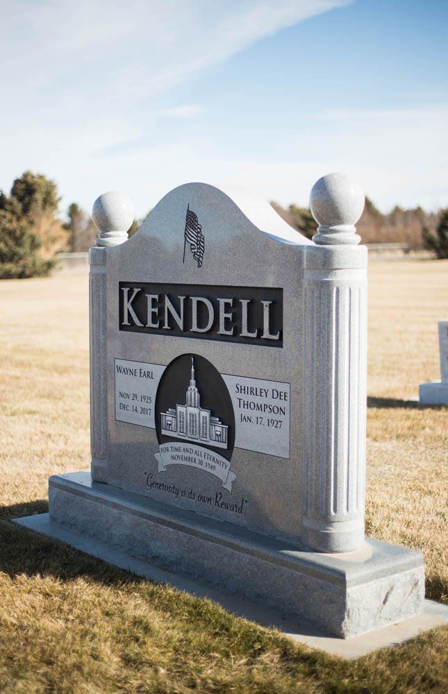 Angled view of Kendell monument with temple design and quote “Generosity is its own Reward”