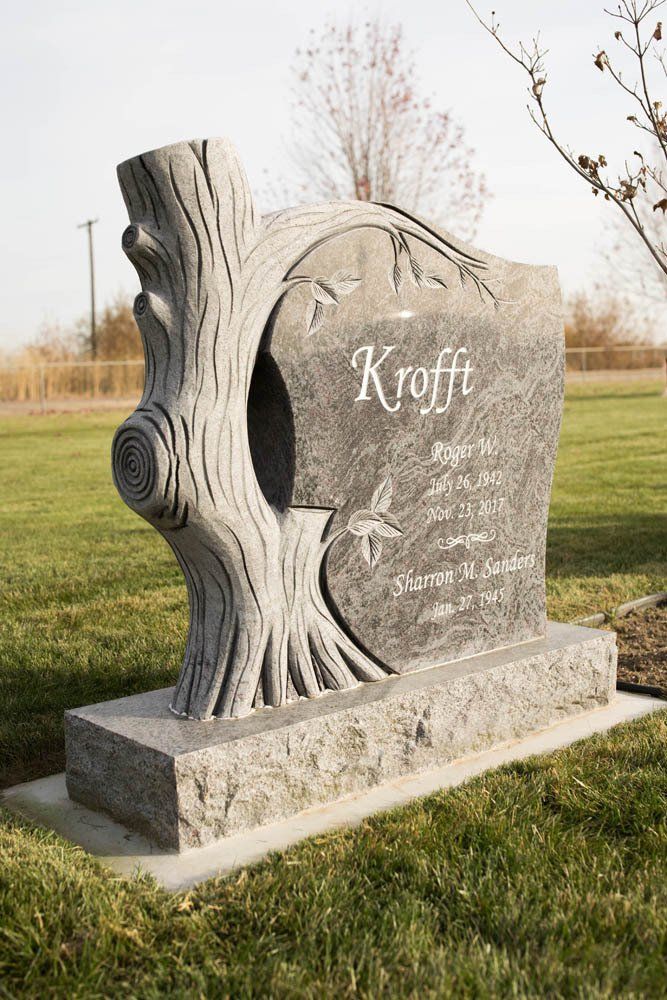 Side view of tree-themed granite headstone for Roger W. and Sharon M. Sanders Krofft