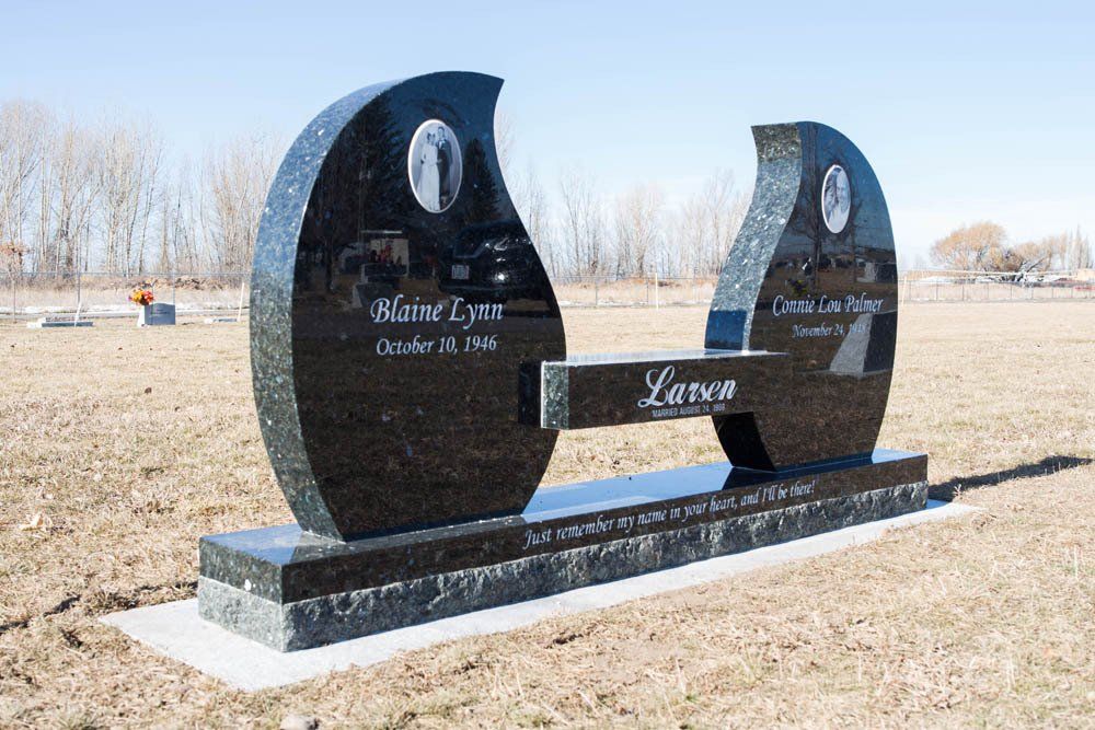Side view of Larsen family black granite headstone with modern split design and engraved quote