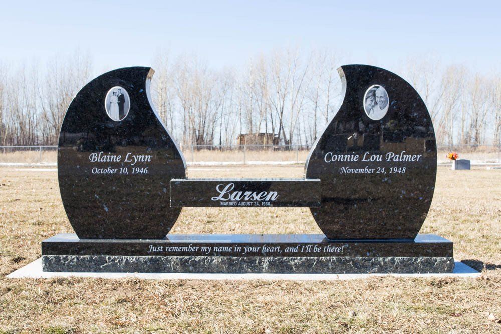 Black granite monument for Blaine Lynn and Connie Lou Palmer Larsen with unique yin-yang inspired design and quote