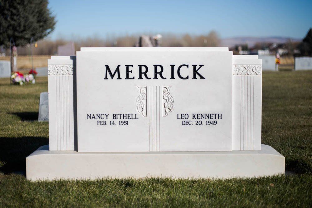 Front view of Merrick family monument with floral side columns and bold engraved surname
