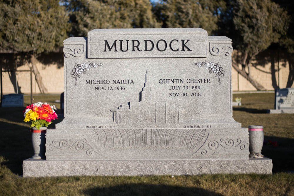 Full front view of Murdock granite monument with floral design and Latter-day Saint temple illustration
