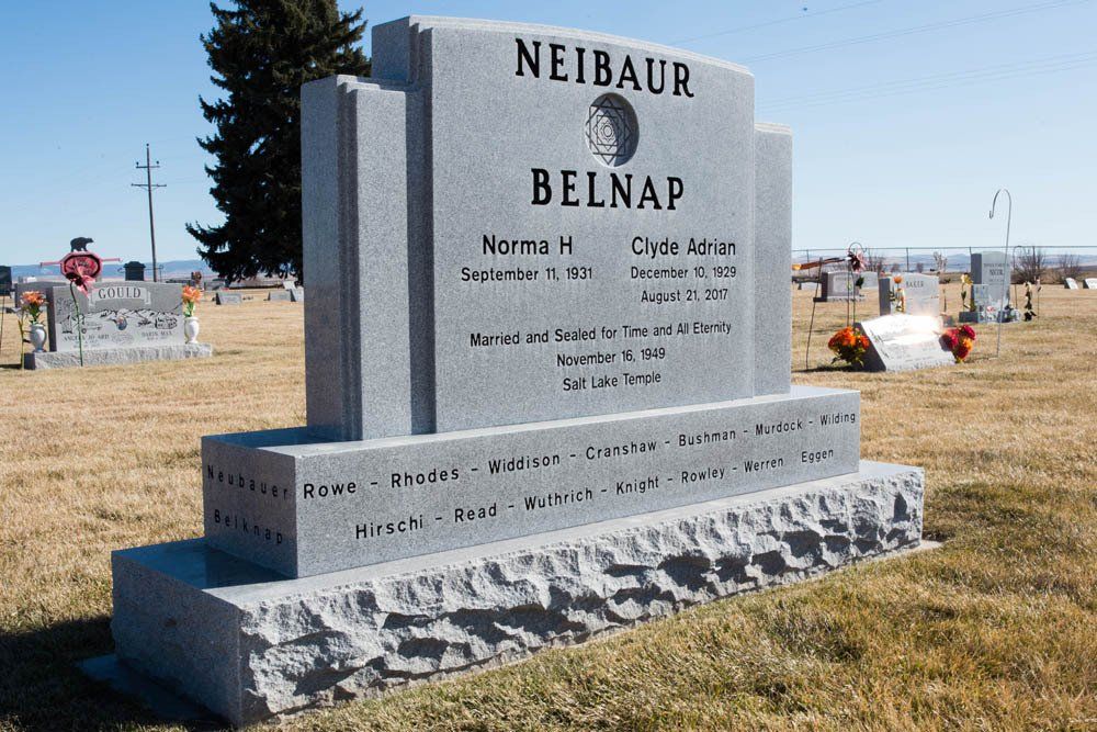 Granite headstone for Norma and Clyde Belnap with engraved surname and extended family names at base