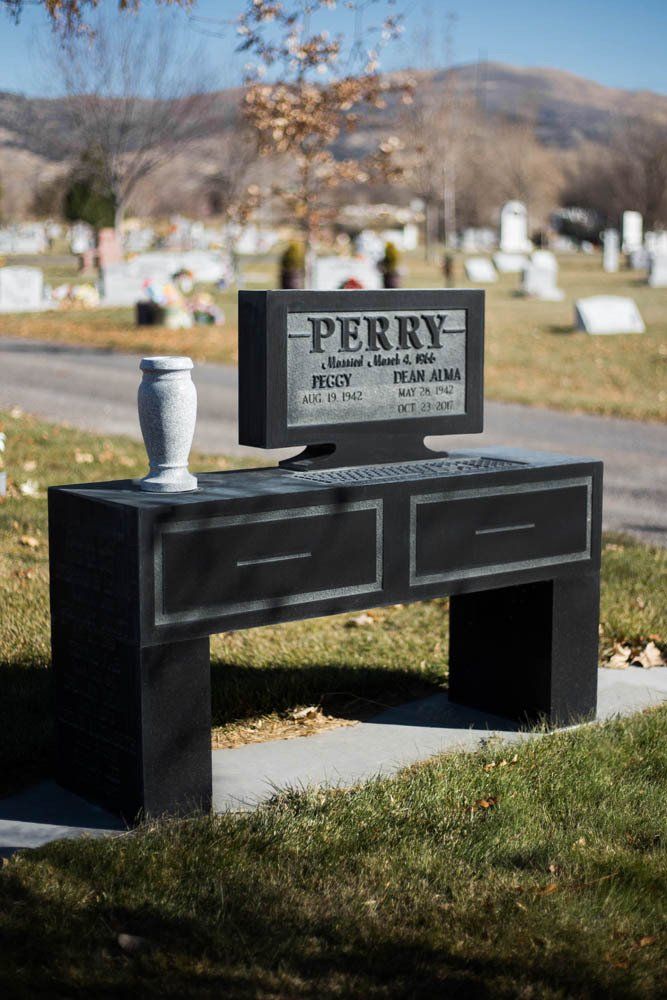 Unique computer desk–shaped headstone for Peggy and Dean Alma Perry with vase on top